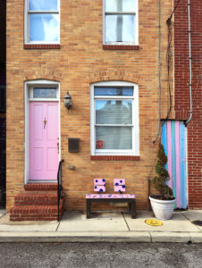 a giant pink flamingo in front of the café hon in the hampden neighborhood of baltimore, maryland, photographed by jamie bannon photography.