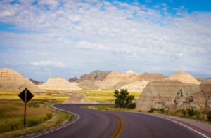 the road through badlands national park in south dakota, photographed by jamie bannon photography.