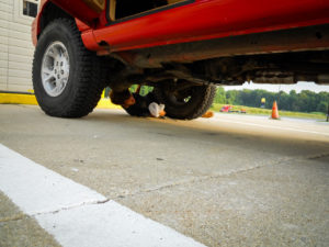a man fixes a broken down jeep at a rest area, photographed by jamie bannon photography.