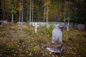 a cemetery full of  wooden gravestones on the hike from mccarthy to kennecott, alaska, photographed by jamie bannon photography.