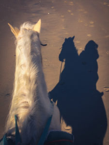 riding a horse on rosarito beach, baja california, mexico, photographed by jamie bannon photography.