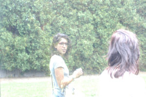 portrait of a woman in the reflection of a sculpture at the walker art center sculpture garden in minneapolis, minnesota.