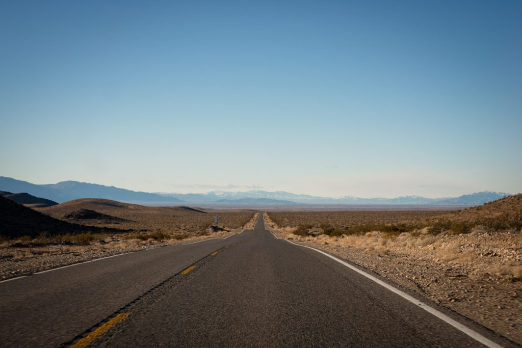 long road through the desert in death valley, california, photographed by jamie bannon photography.