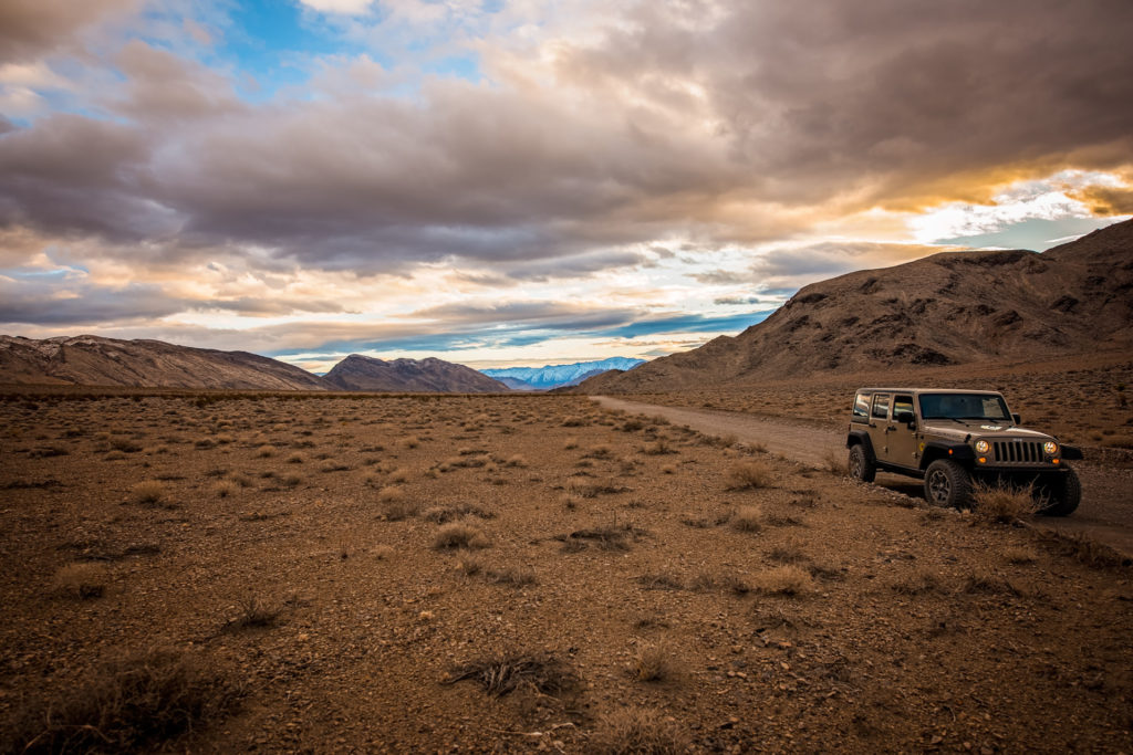 jeep wrangler on the dirt road to the racetrack playa in death valley, california, photographed by jamie bannon photography.