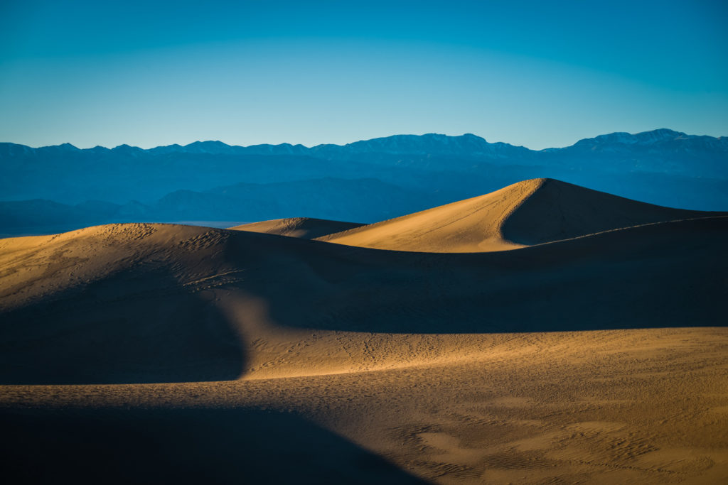 golden hour sunset over the sand dunes in death valley, california, photographed by jamie bannon photography.
