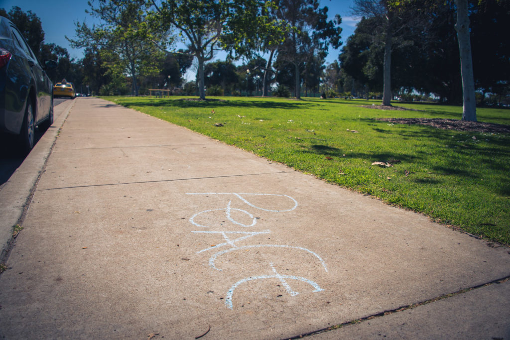 a message of peace written in sidewalk chalk san diego, california, photographed by jamie bannon photography.