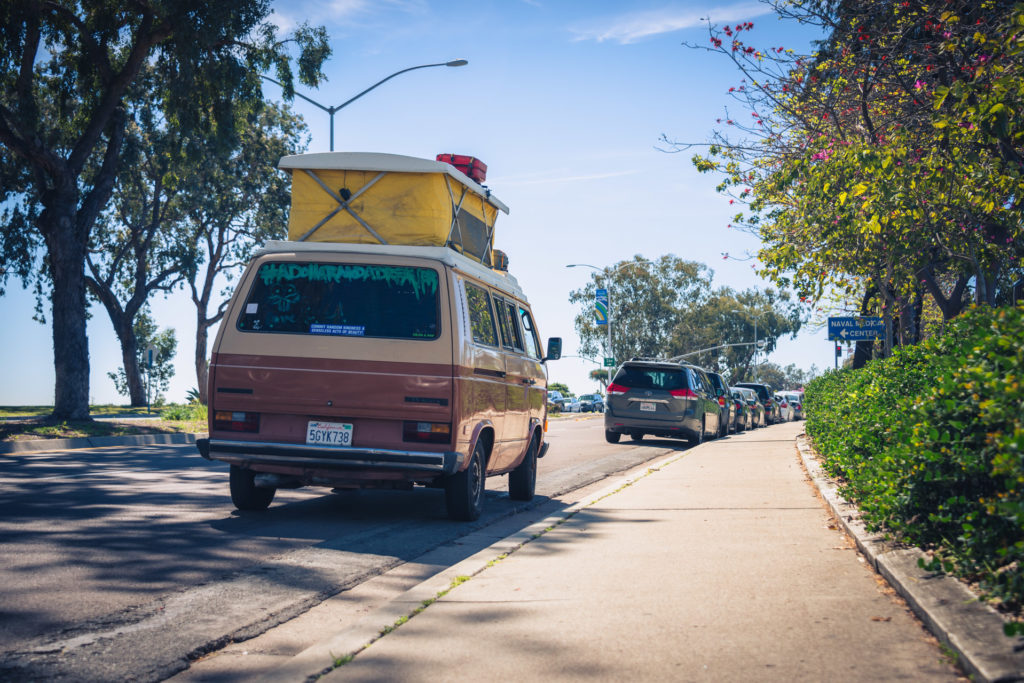 a camper van is parked on the side of the road near the san diego zoo, photographed by jamie bannon photography.