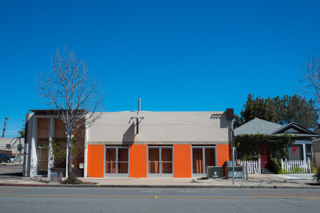 a building with brightly painted orange brick in san diego, california, photographed by jamie bannon photography.