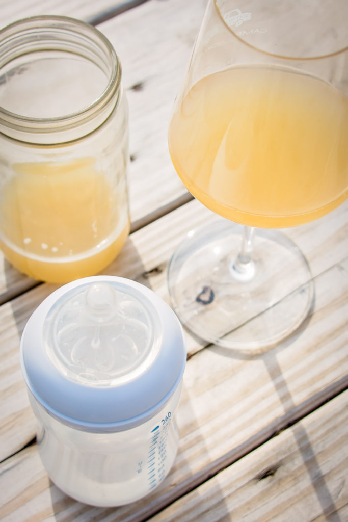 two beers and a baby bottle on the outside patio at kent falls brewing company in kent, connecticut, photographed by jamie bannon photography.