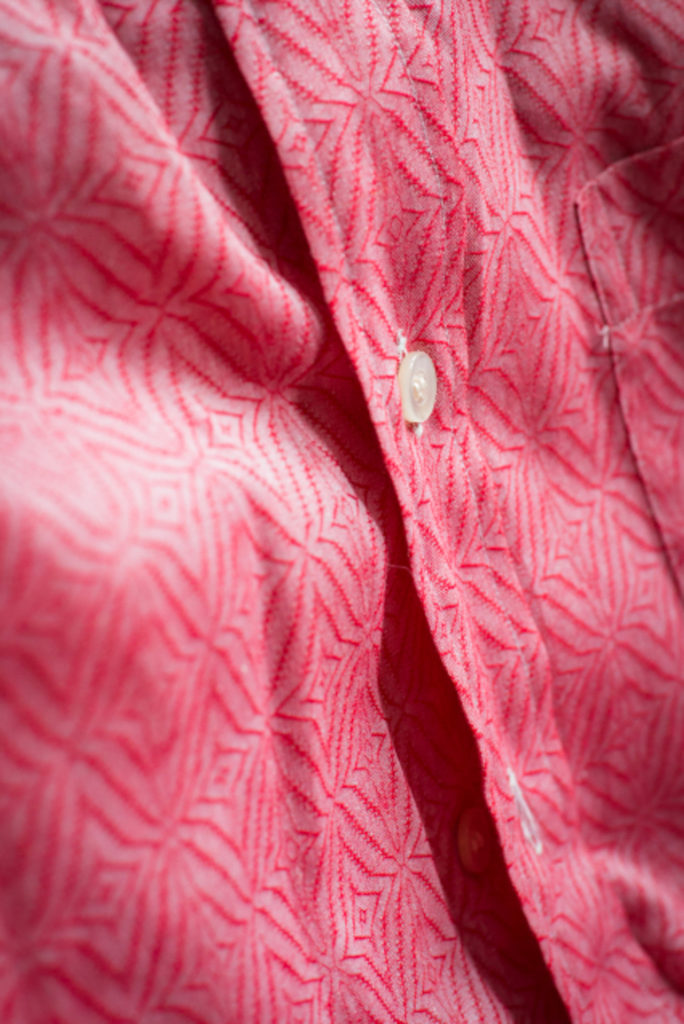 detail of a red patterned button-down shirt at comma, vintage menswear subscription service, taken for a brand shoot by jamie bannon photography.