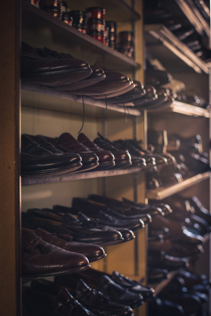 rows of shoes in a cobbler shop in unionville, connecticut, photographed by jamie bannon photography.