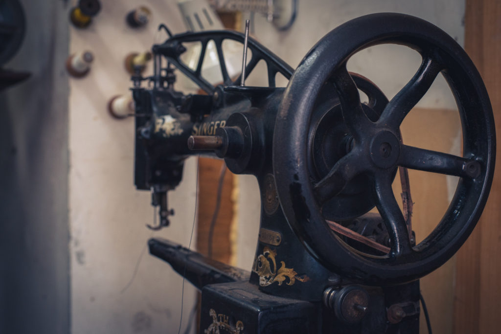 old singer sewing machine in a cobbler shop in unionville, connecticut, photographed by jamie bannon photography.