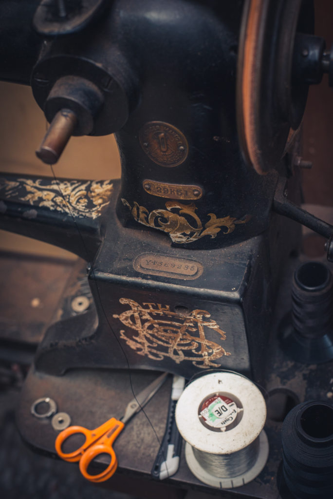 old singer sewing machine in a cobbler shop in unionville, connecticut, photographed by jamie bannon photography.