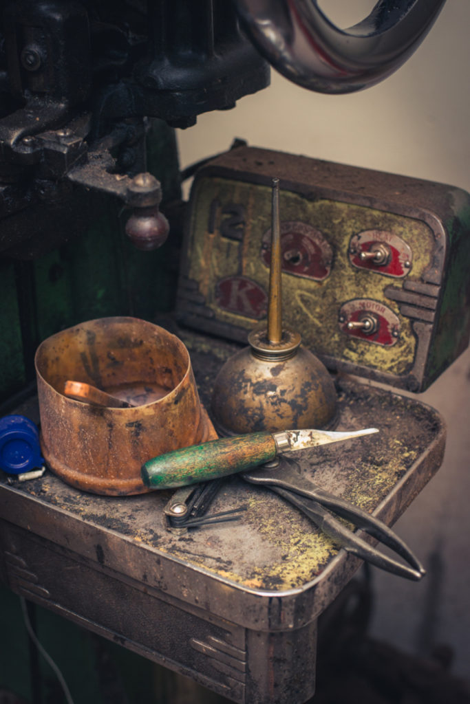 old fashioned shoe repair equipment in a cobbler shop in unionville, connecticut, photographed by jamie bannon photography.