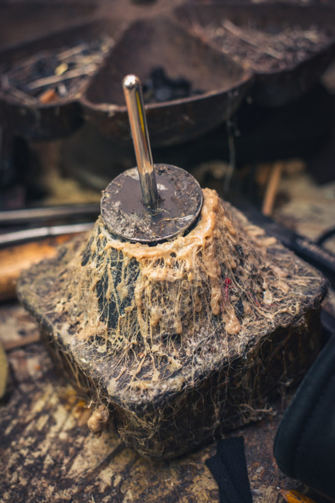 detail of post covered in shoe glue at a cobbler shop in unionville, connecticut, photographed by jamie bannon photography.