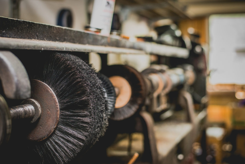 old fashioned shoe repair equipment in a cobbler shop in unionville, connecticut, photographed by jamie bannon photography.