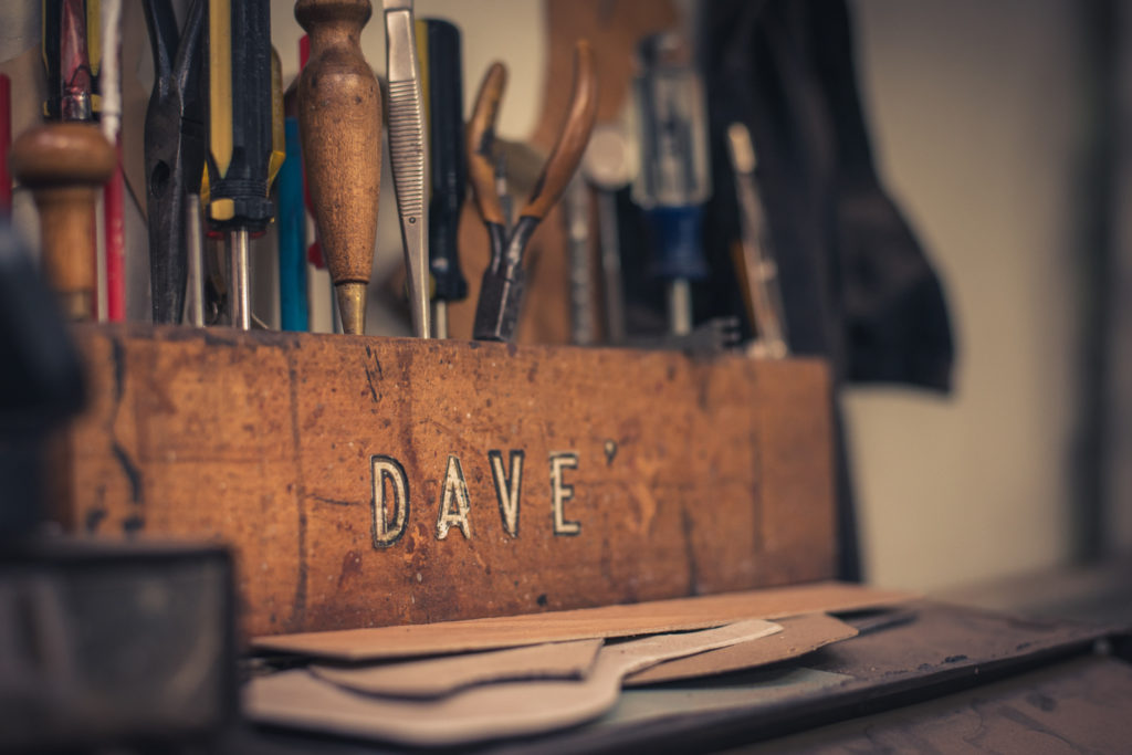 detail of a small tool organizer that reads "dave's" at a cobbler shop in unionville, connecticut, photographed by jamie bannon photography.