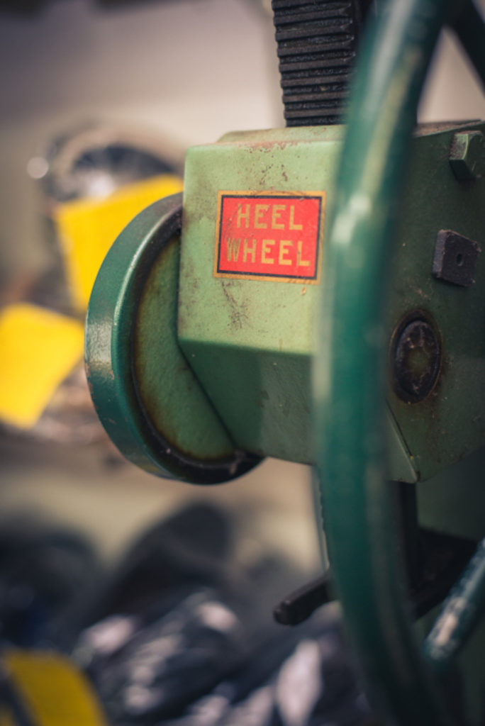 old fashioned shoe repair equipment called a "heel wheel" in a cobbler shop in unionville, connecticut, photographed by jamie bannon photography.