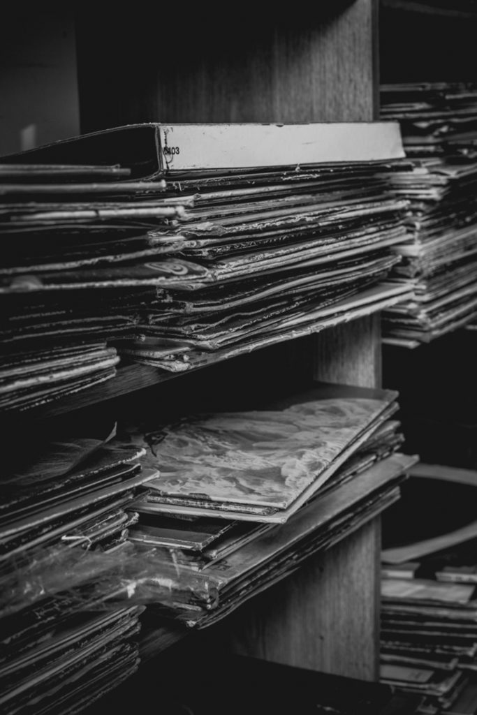 detail of stacks of old records at a cobbler shop in unionville, connecticut, photographed by jamie bannon photography.