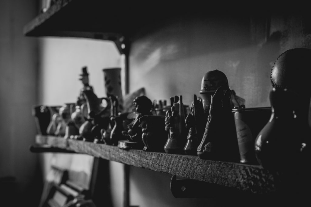detail of knick knacks lining the shelves of a cobbler shop in unionville, connecticut, photographed by jamie bannon photography.