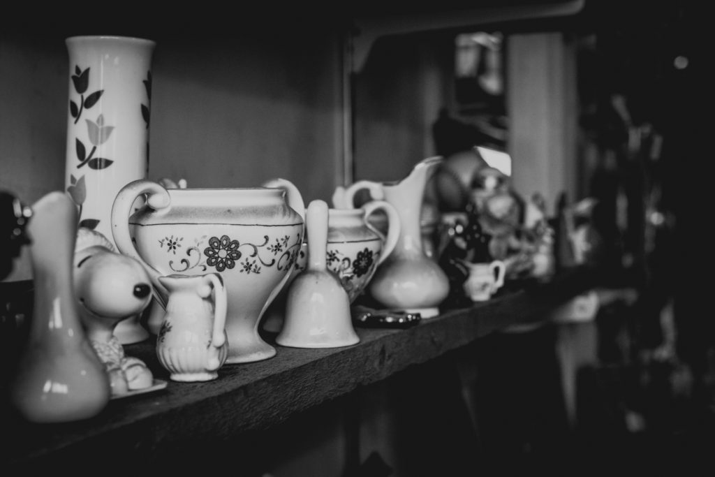 detail of knick knacks lining the shelves of a cobbler shop in unionville, connecticut, photographed by jamie bannon photography.