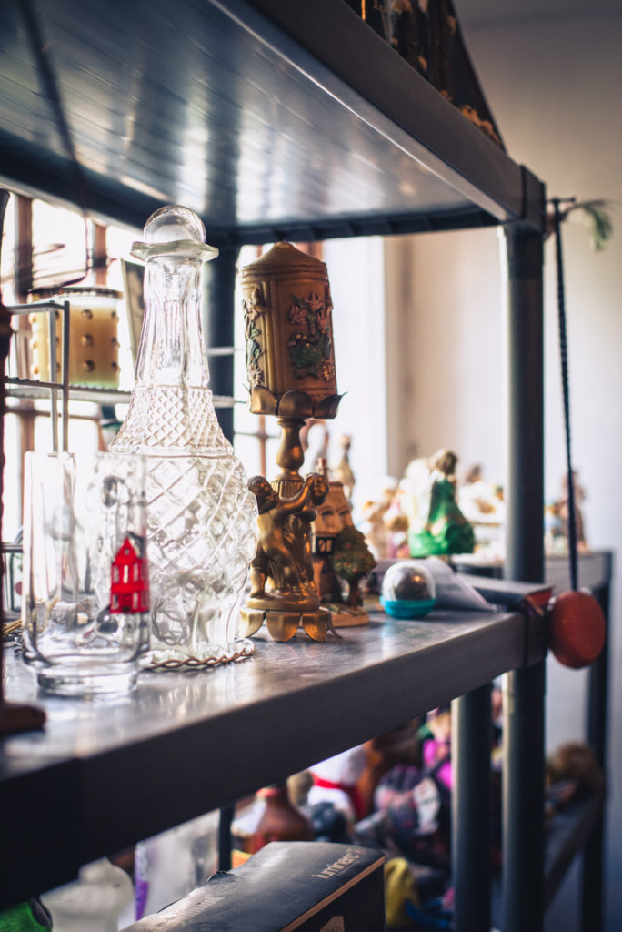 detail of knick knacks lining the shelves of a cobbler shop in unionville, connecticut, photographed by jamie bannon photography.