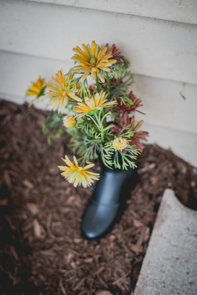 a shoe used as a flower planter outside dave's shoe repair cobbler shop in unionville, connecticut, photographed by jamie bannon photography.