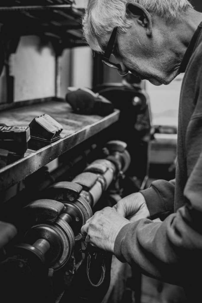 black and white portrait of a cobbler working in his shoe repair shop in unionville, connecticut, photographed by jamie bannon photography.