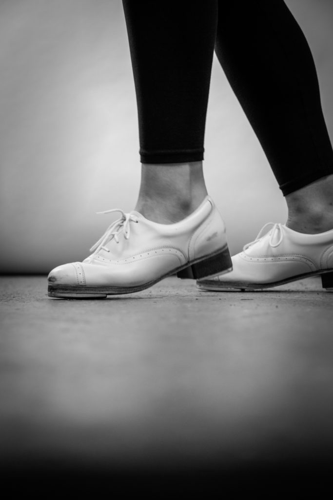 black and white close-up of a tap dancer's feet, photographed by jamie bannon photography.