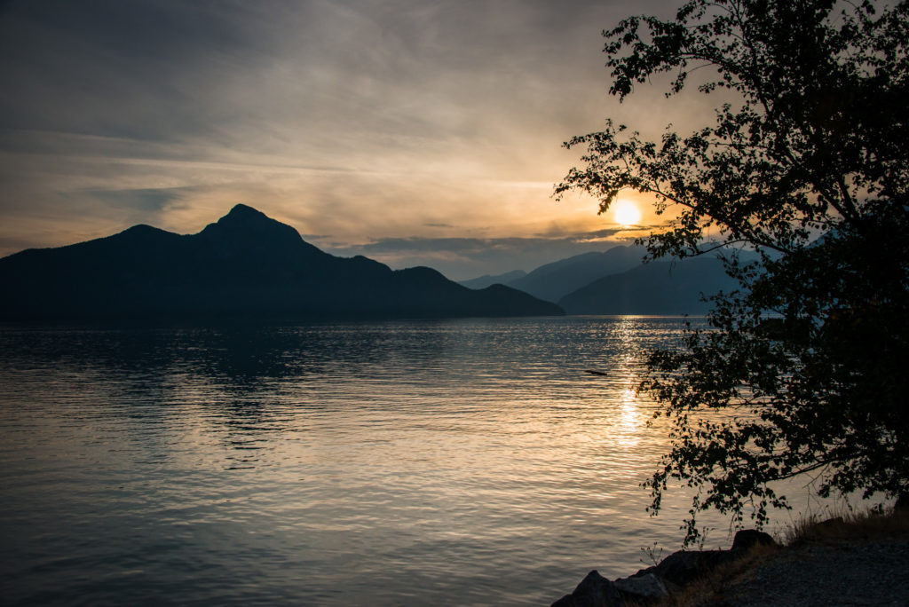 sunset over the mountains and water at porteau cove provincial park, british columbia, photographed by jamie bannon photography.
