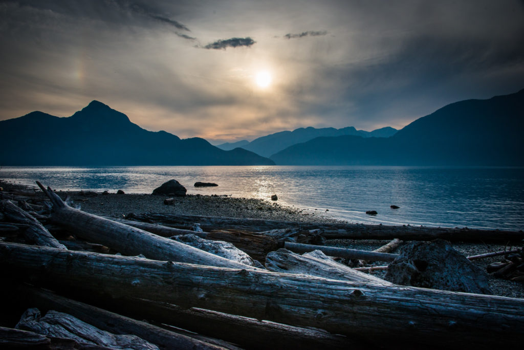 sunset over the water at porteau cove provincial park, british columbia, photographed by jamie bannon photography.