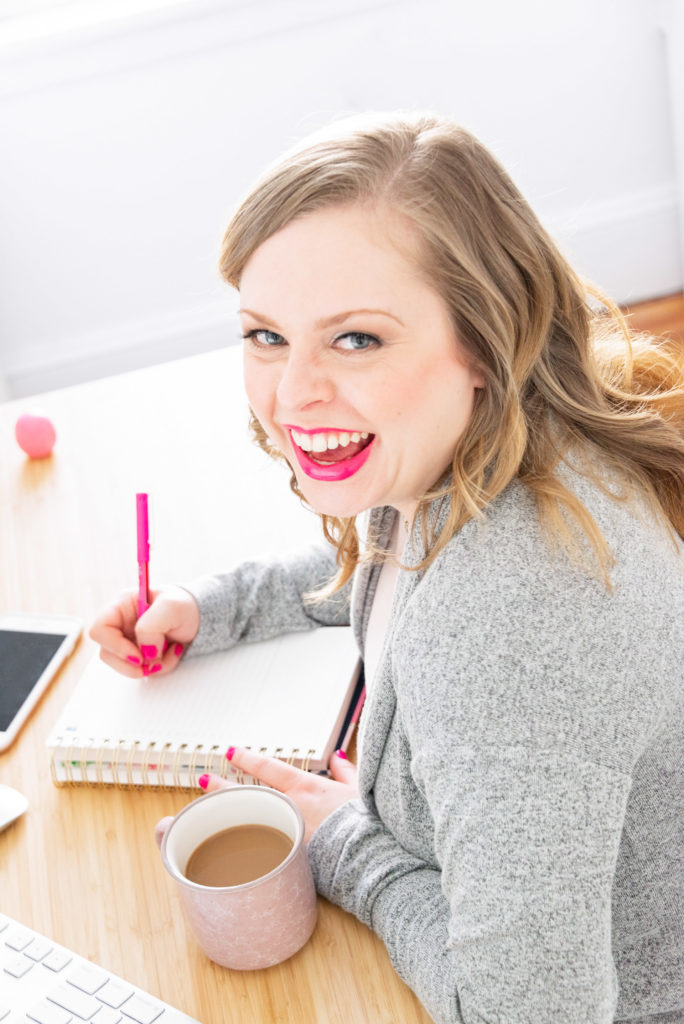 a female entrepreneur laughs at her desk, as part of a business branding shoot for the productivity zone, photographed by jamie bannon photography.