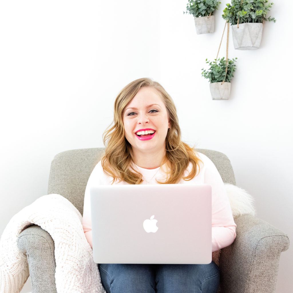 a female entrepreneur works on her laptop in a comfy chair, as part of a personal branding shoot by jamie bannon photography.