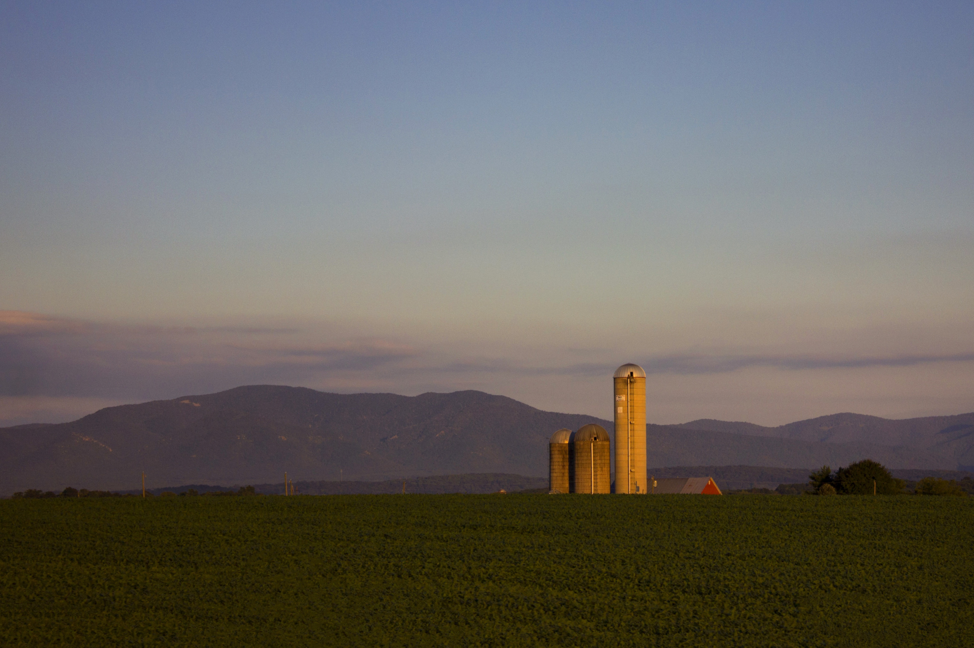 a farm with silos, somewhere in rural america, photographed by jamie bannon photography.