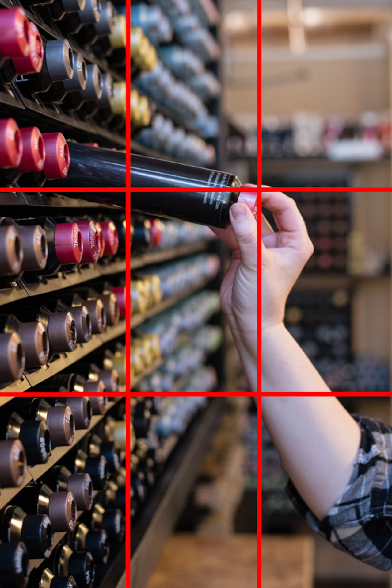 a salon stylists reaches for a bottle of color, illustrating the rule of thirds, by jamie bannon photography.